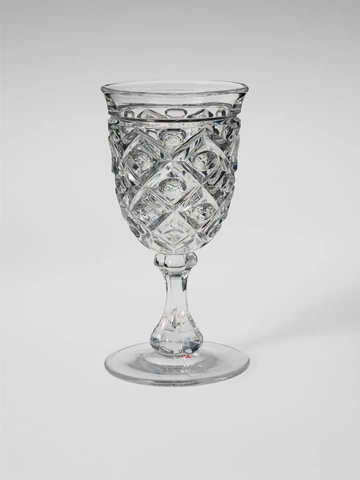 Original photo: a cut-glass goblet with a diamond pattern, against a light grey background